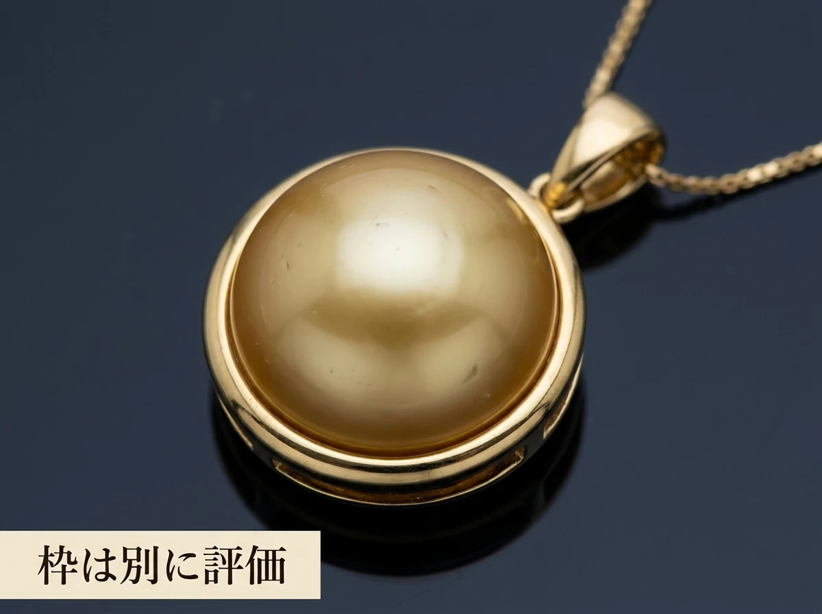 金の枠に留められた金色の真珠のペンダントの写真